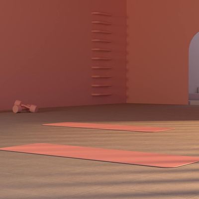 Clean and empty workout space with a yoga mat on the floor.