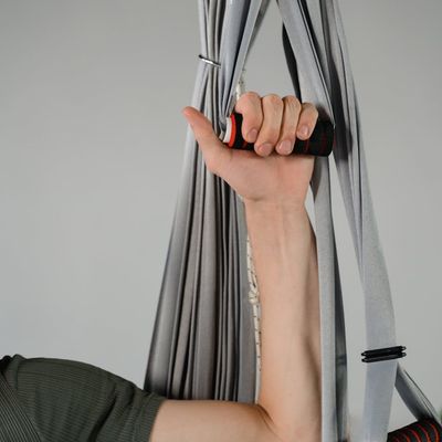 Close-up shot of a hand gripping the floor during a push-up exercise.