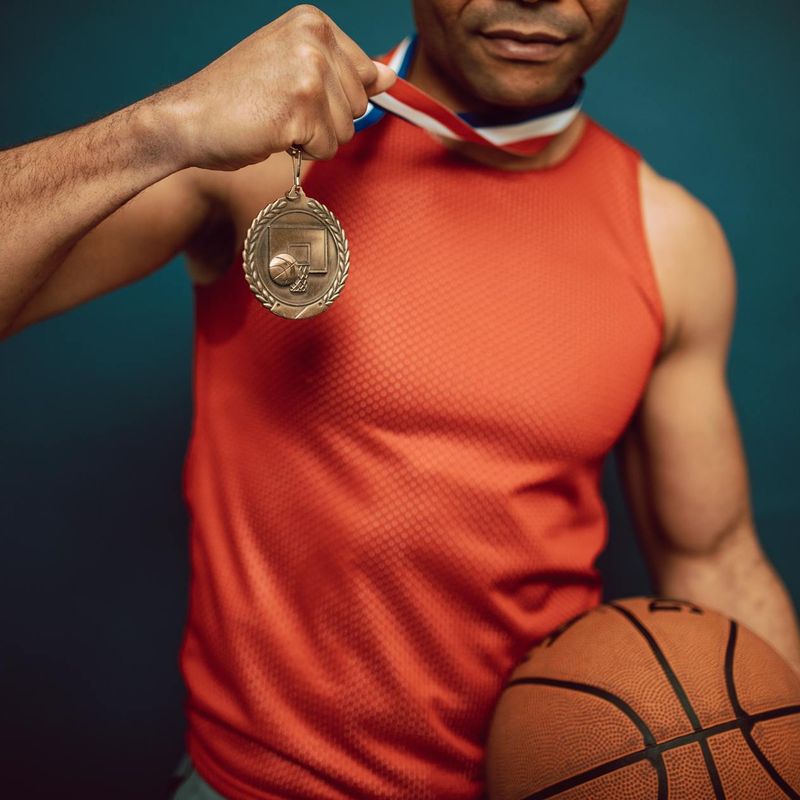 Man holding a difficult static pose, showing muscle definition and focus.